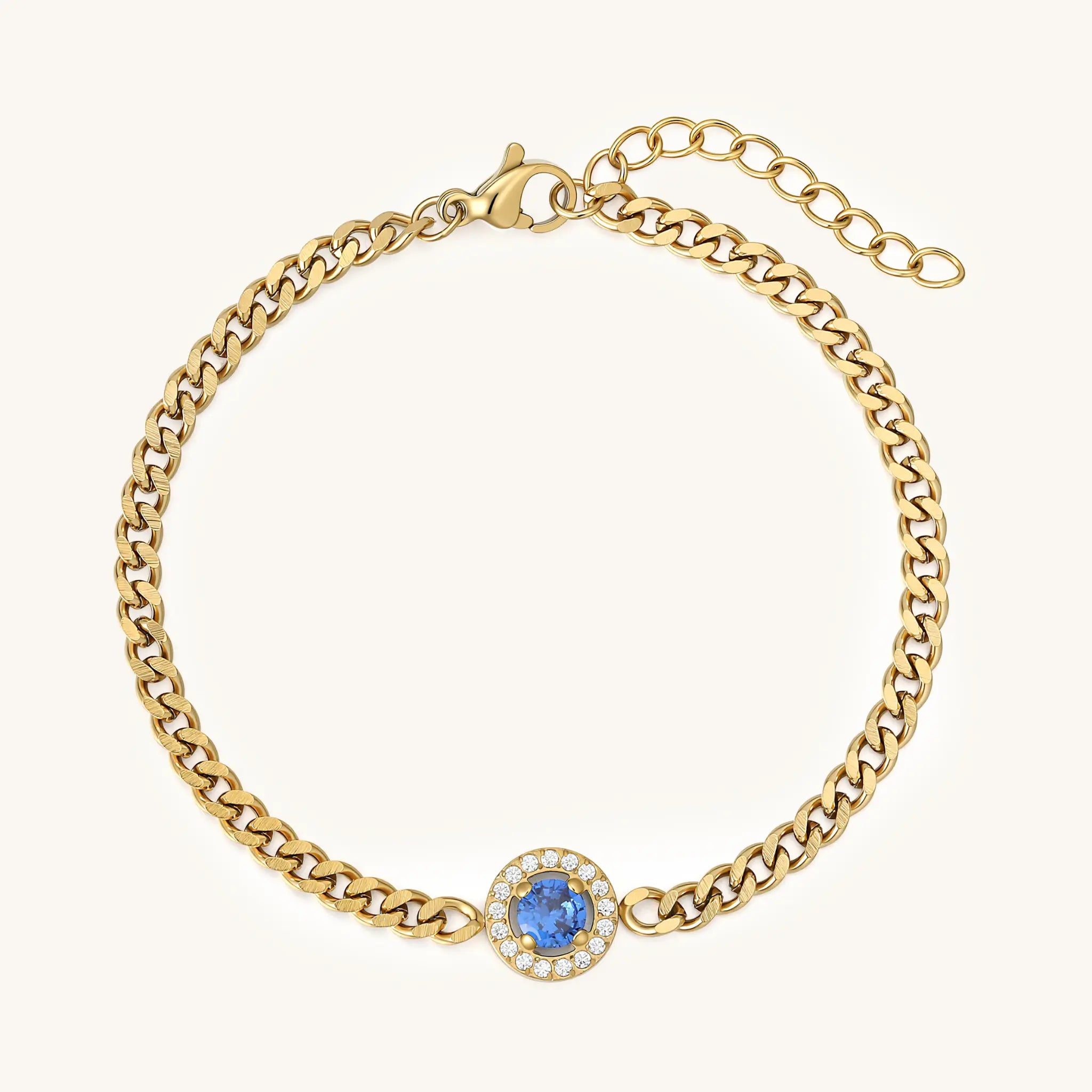 Top view of Vilrian gold curb chain bracelet with blue crystal center and extender chain