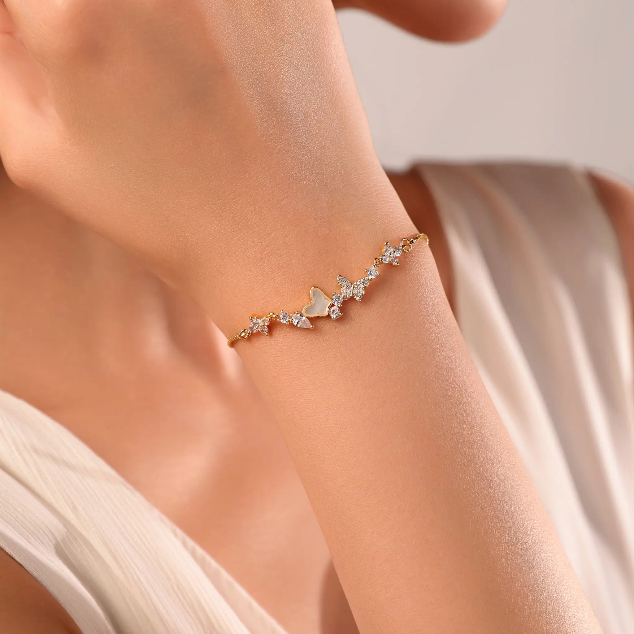 Woman wearing Vilrian gold butterfly bolo bracelet on wrist