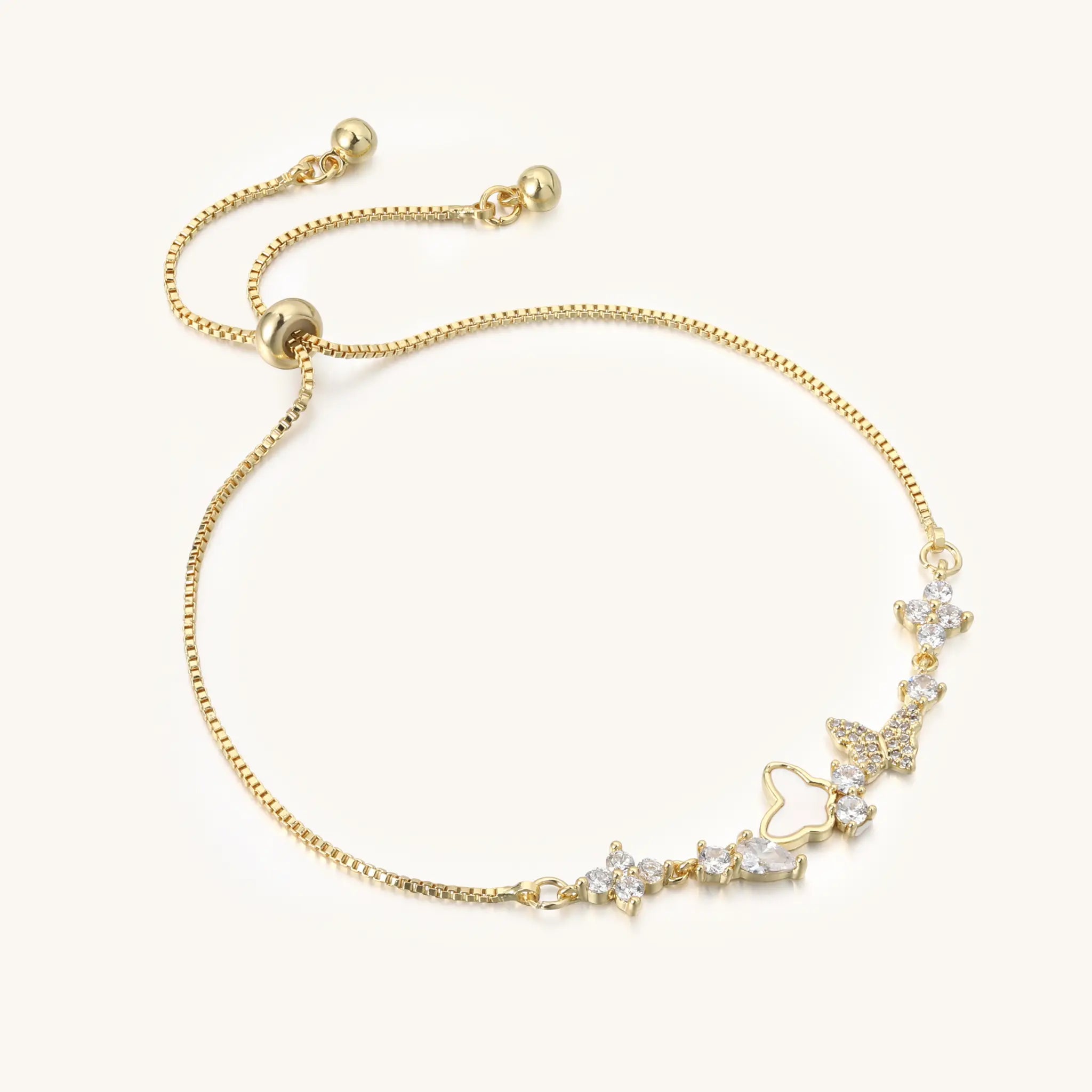 Perspective view of Vilrian gold charm bracelet showing slider bead and cz butterfly details
