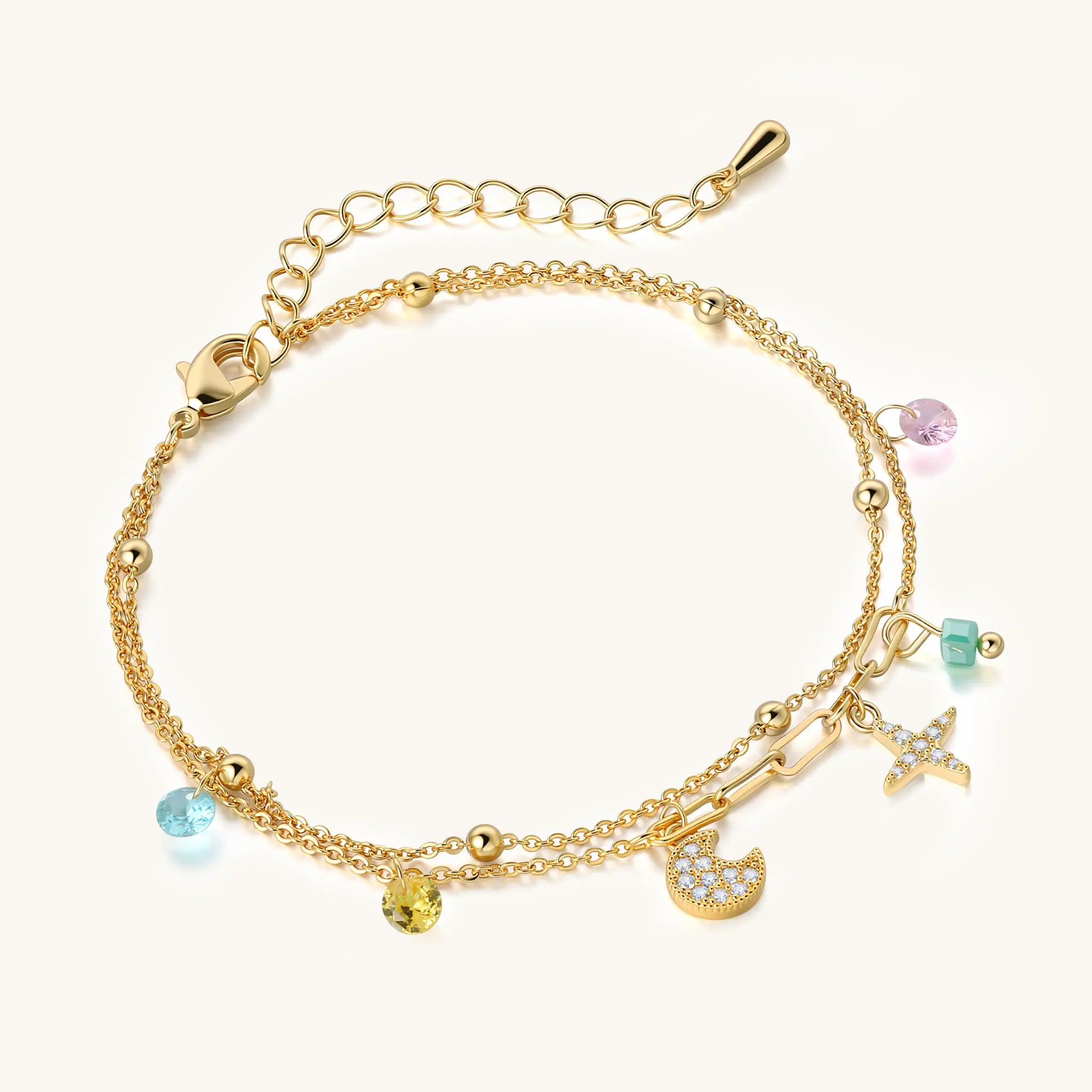 Close up of Vilrian gold celestial bracelet with pastel beads and sparkling cz charms