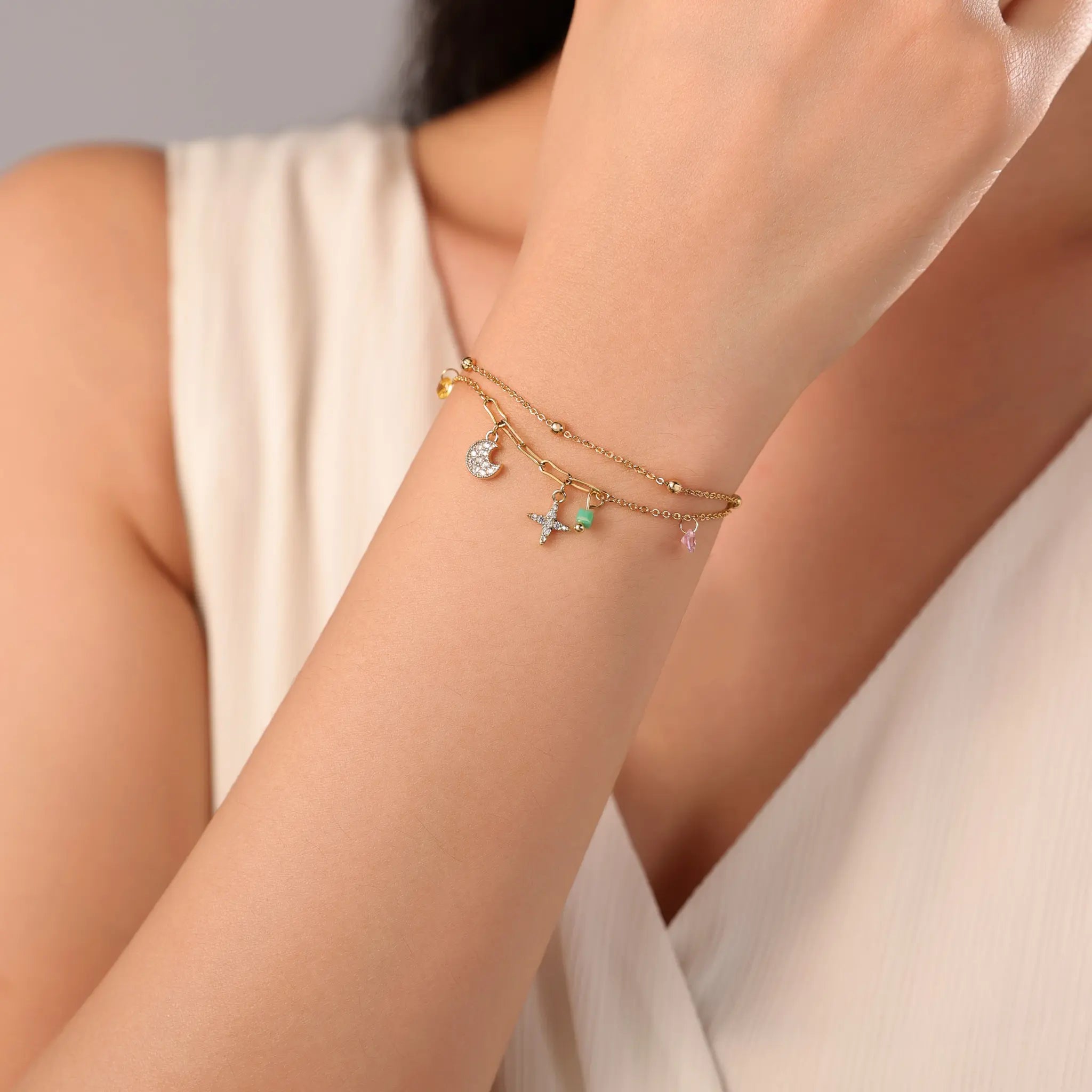 Woman wearing Vilrian celestial double layer charm bracelet on wrist