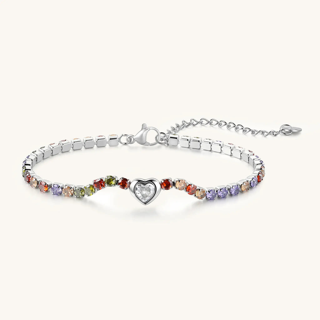 Angle view of Vilrian silver rainbow CZ heart tennis bracelet showing lobster clasp and extender