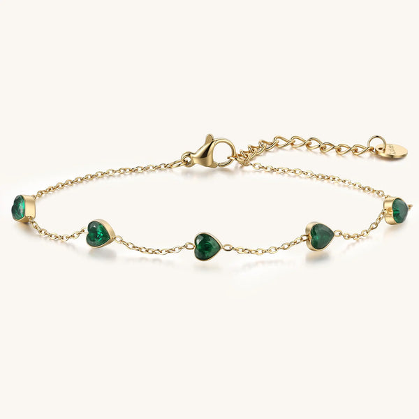 Vilrian gold plated stainless steel station bracelet with heart shaped emerald green zirconia