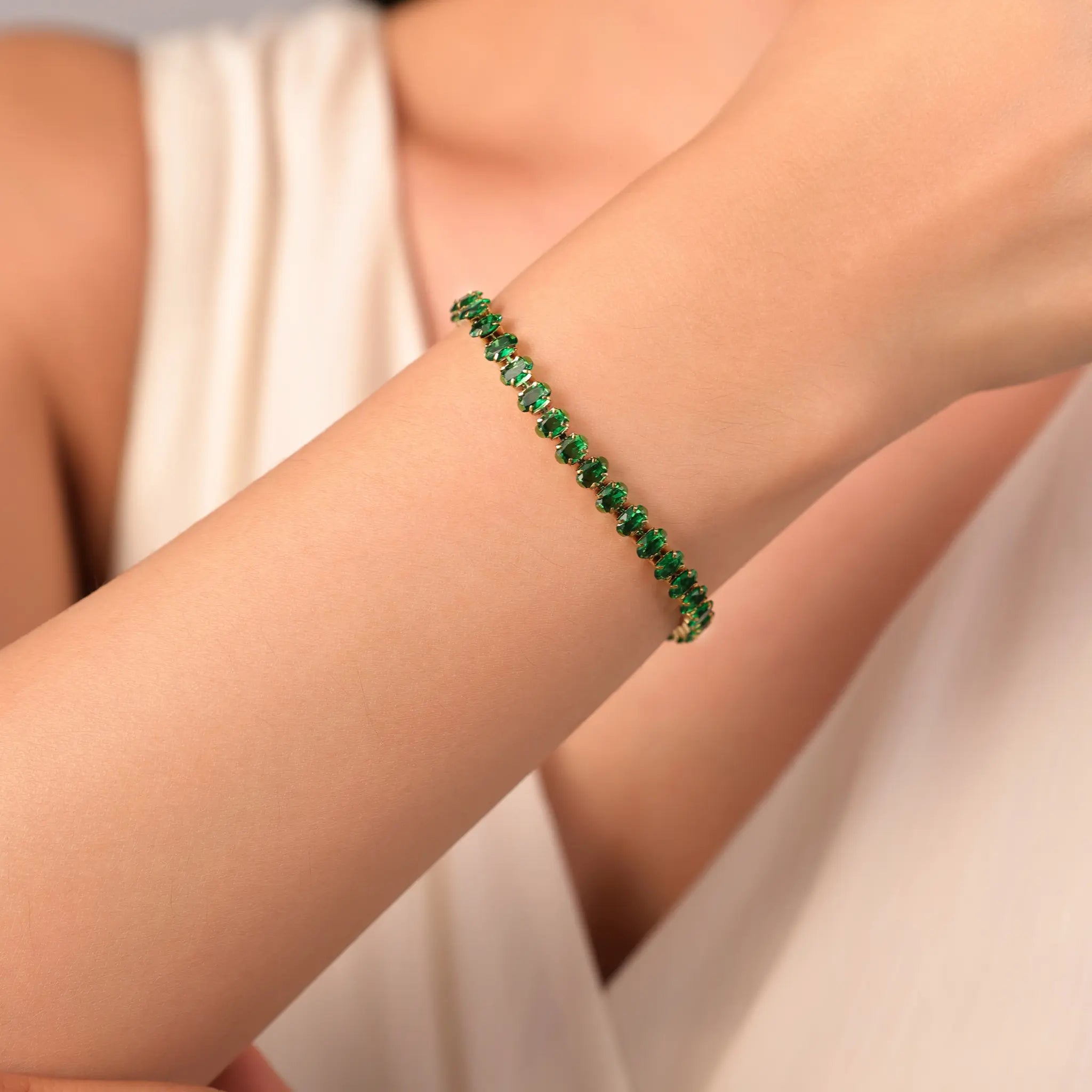 Woman wearing Vilrian emerald green zirconia tennis bracelet on wrist