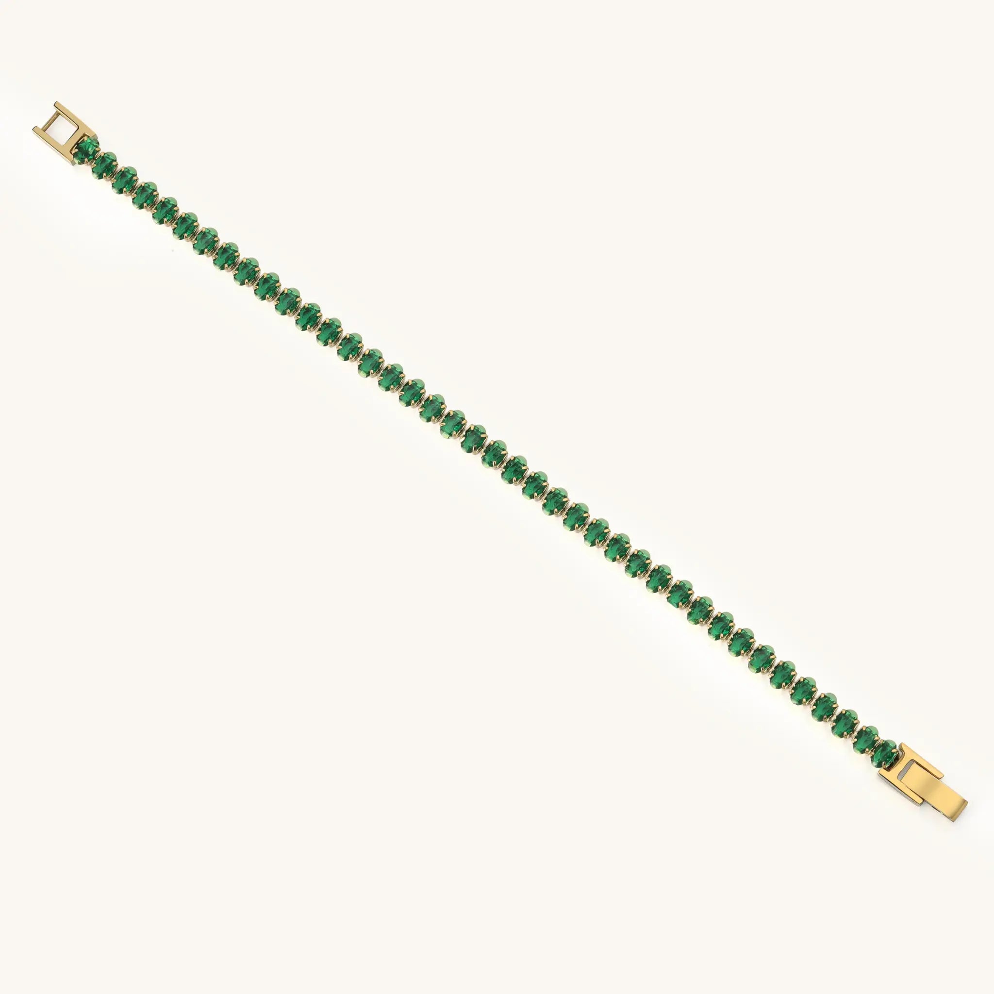 Full length flat lay of Vilrian gold plated stainless steel emerald green tennis bracelet