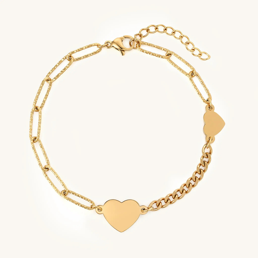 Top view of Vilrian gold asymmetric chain bracelet featuring heart charm and lobster clasp