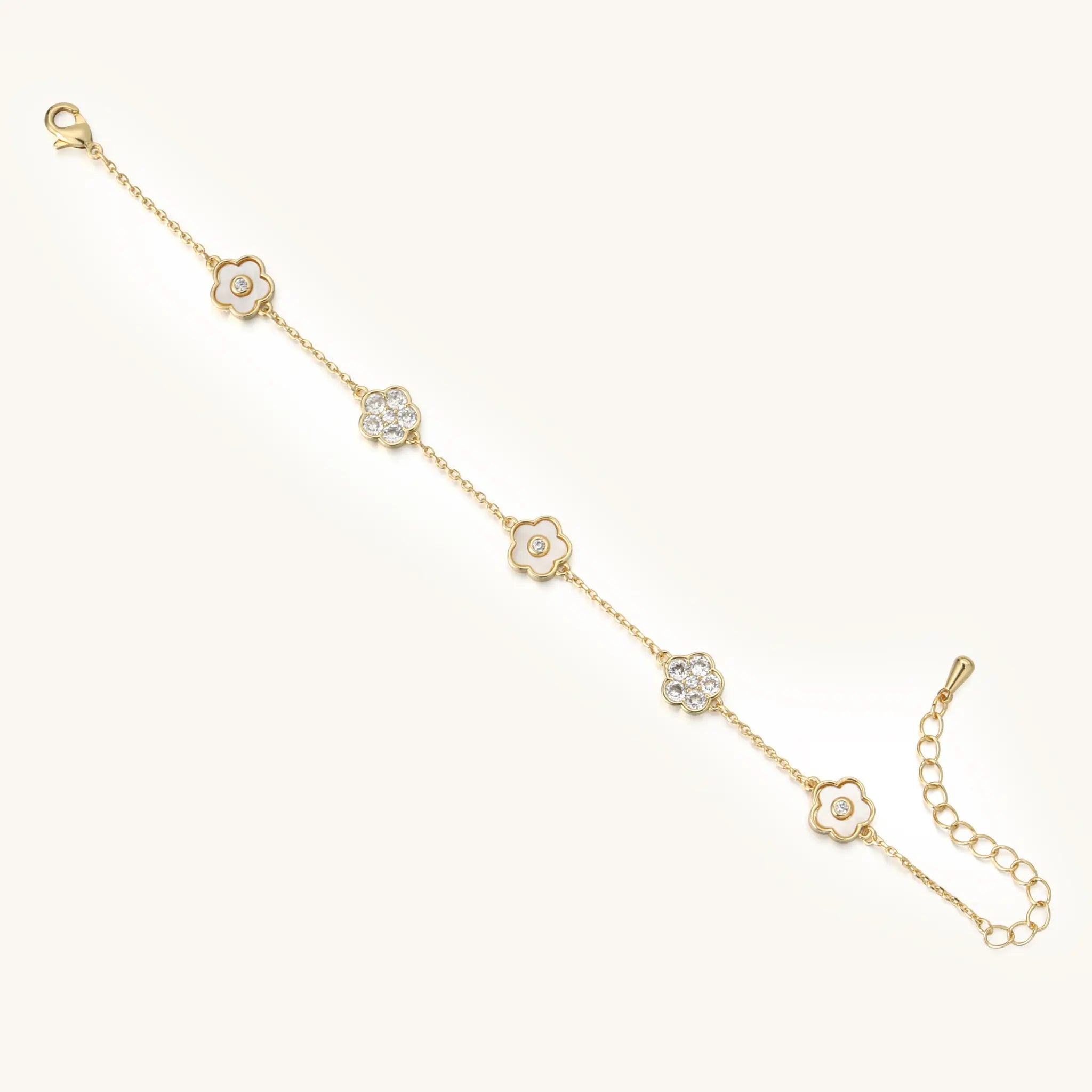 Full length flat lay view of Vilrian gold flower charm bracelet
