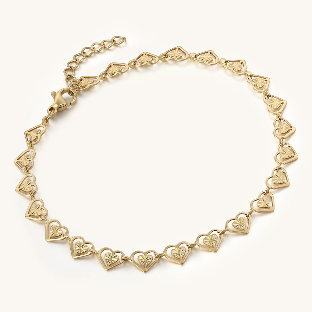 Perspective view of Vilrian gold textured heart link bracelet showing lobster clasp and extender