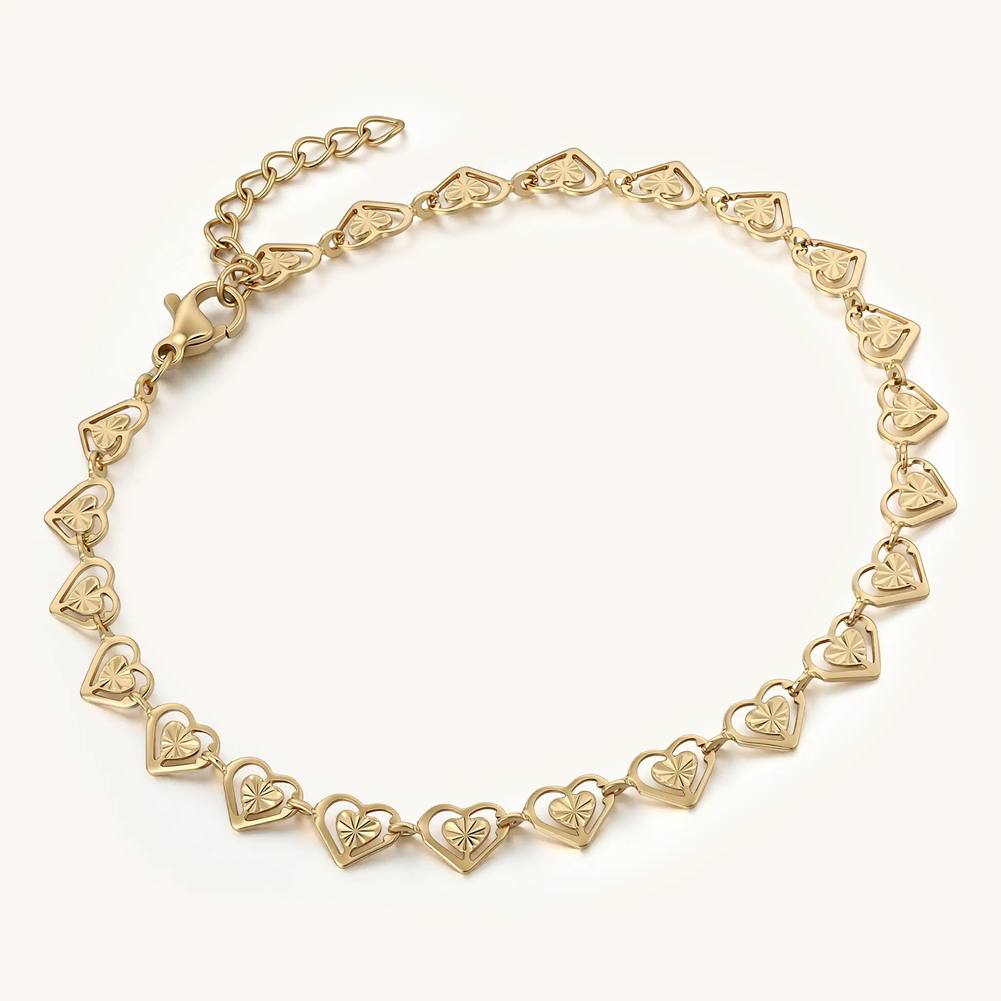 Perspective view of Vilrian gold textured heart link bracelet showing lobster clasp and extender