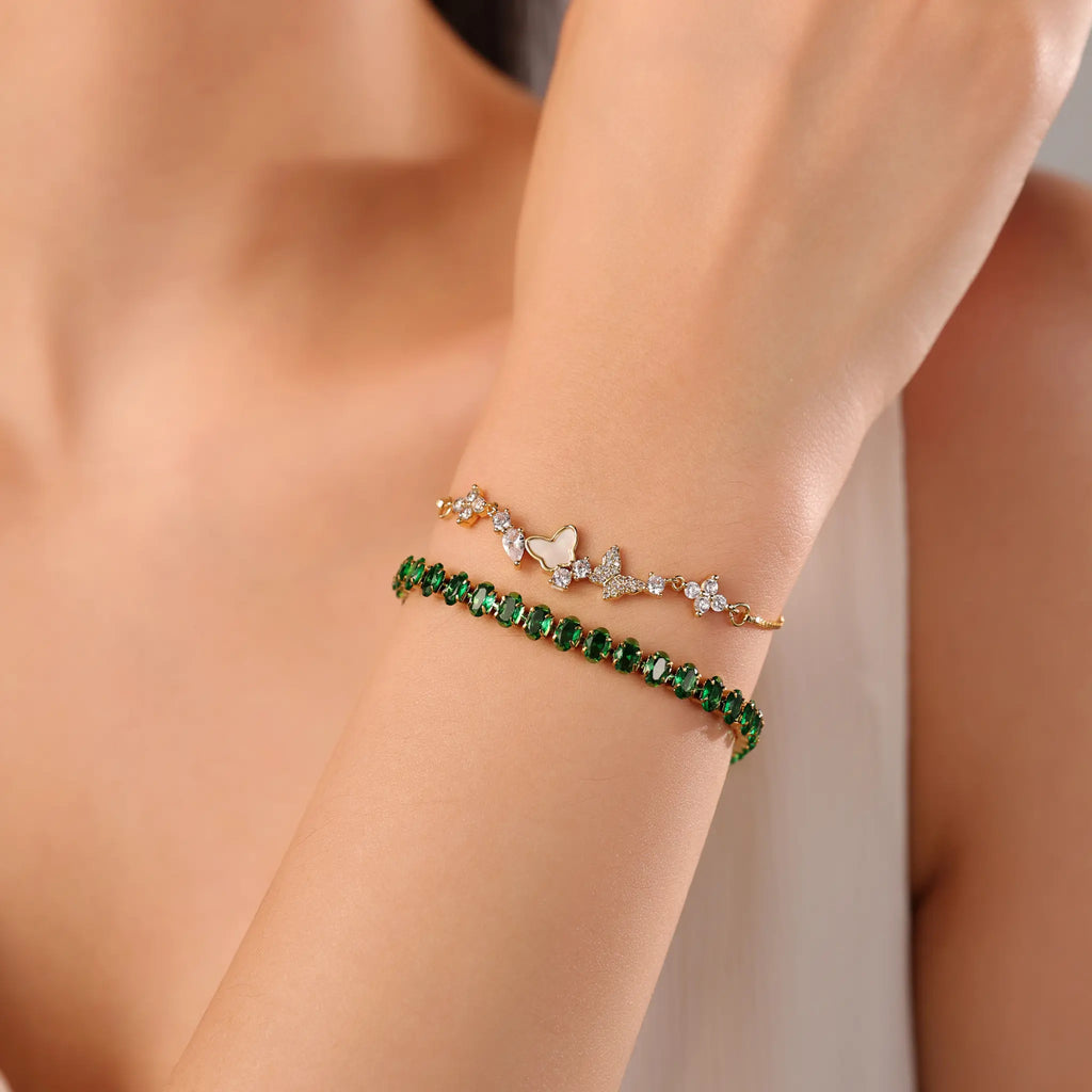 Gold bracelet stacking inspiration with Vilrian green tennis bracelet and butterfly bolo bracelet