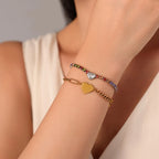 Mixed metal bracelet layering look featuring Vilrian silver rainbow CZ heart bracelet and gold smooth heart bracelet