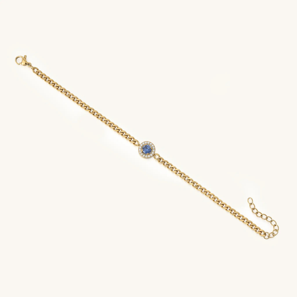 Full length lay flat of Vilrian gold stainless steel curb bracelet with royal blue halo gem